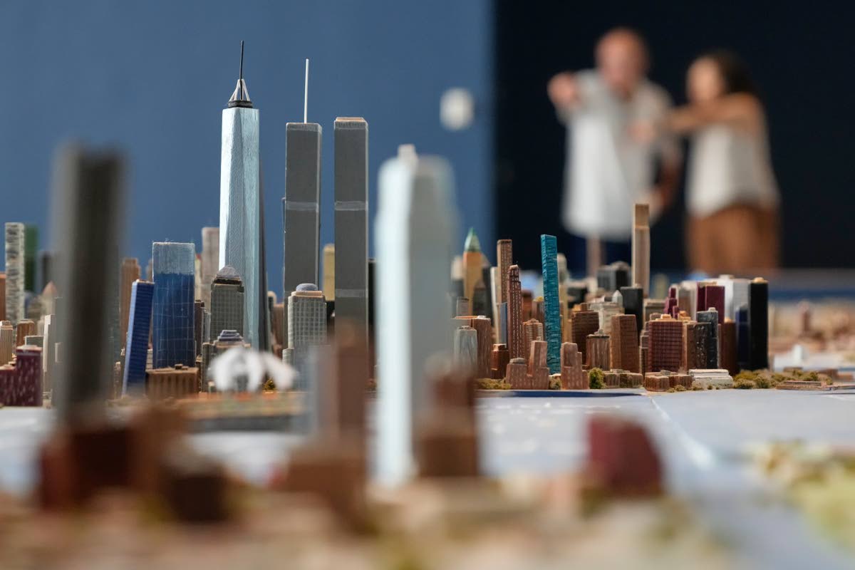 Lower Manhattan, featuring both the One World Trade and the Twin Towers, is seen on a large model of the New York City, made by Joe Macken, at the Museum of the City of New York in New York