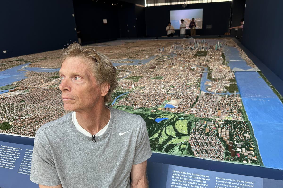 In this image taken with a smartphone, truck driver Joe Macken poses in front of his scale model of New York City.
