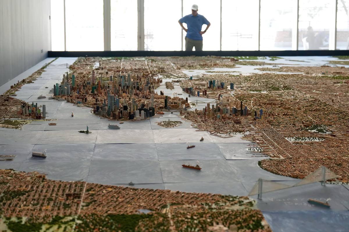 A visitor to the Museum of the City of New York looks over a model of New York City made by Joe Macken in New York.