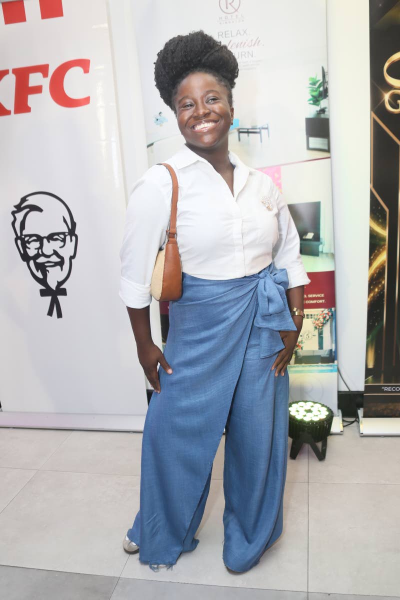 Djaunel Lawrence, media practitioner, keeps things crisp in a white button-down shirt and wrap-tie wide-leg trousers.