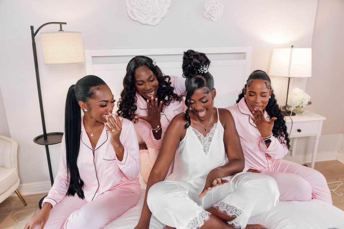 Reneé Hamilton-Clarke (second right) flashes her ring to her bridal party. From left are maid of honour Cherone Johnson, the bride’s sister Monique Hamilton, and Amanda Sturridge.