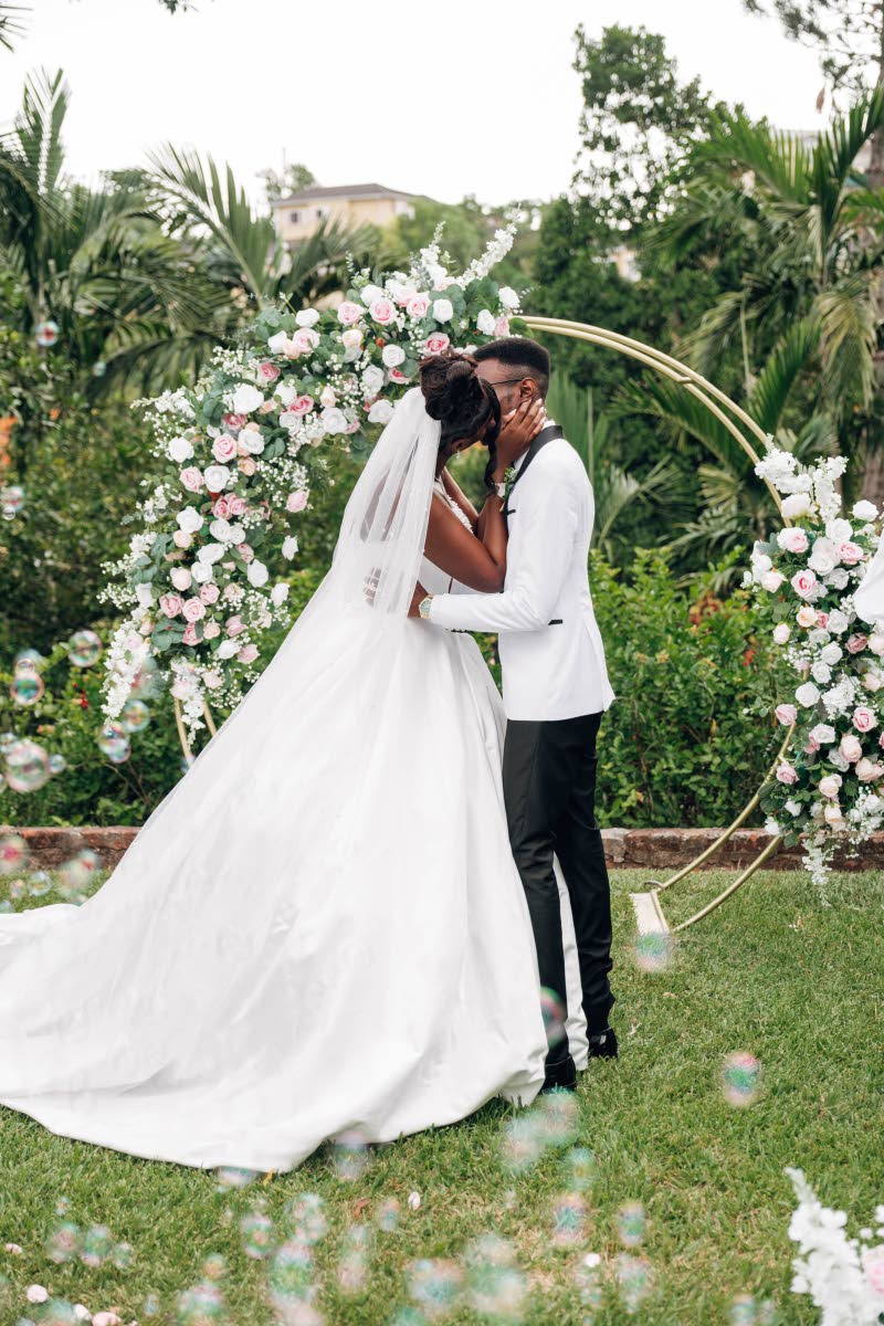 Mr and Mrs Malik Clarke sealed their commitment with a kiss. 