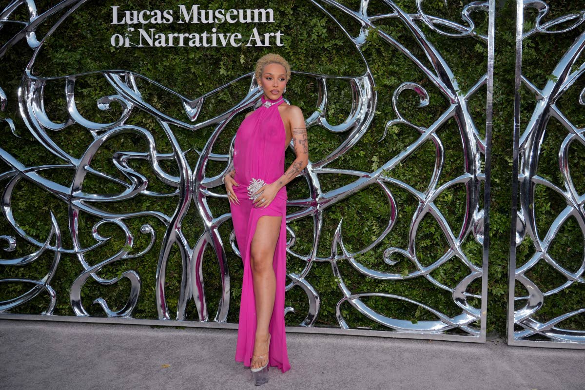 Right: Doja Cat goes pink with a daring high slit for the occasion. 