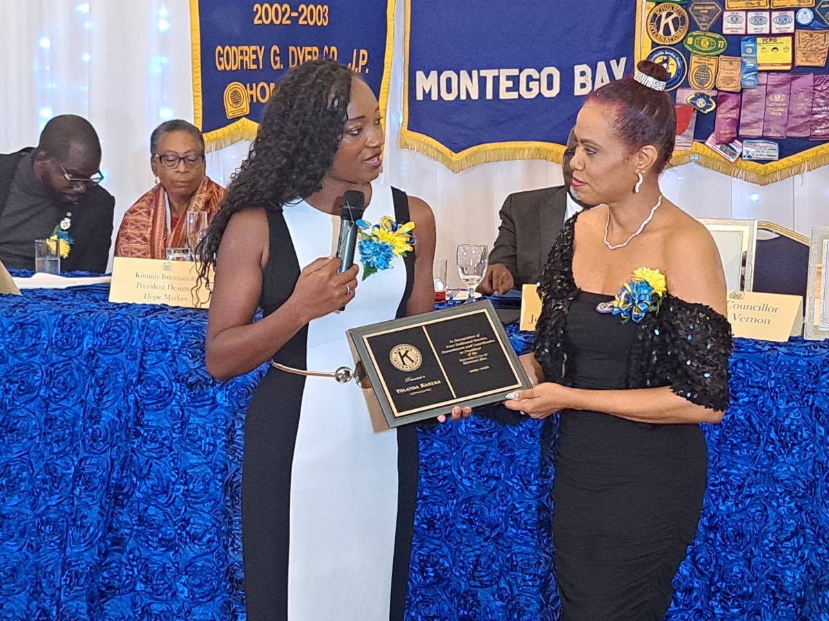Jo-Dane Russell Guerra (left), newly installed president of the Kiwanis Club of Montego Bay, presents a token of appreciation to immediate past president Yolanda Kameka during the club’s 60th-anniversary luncheon and installation ceremony at the Grand-A-