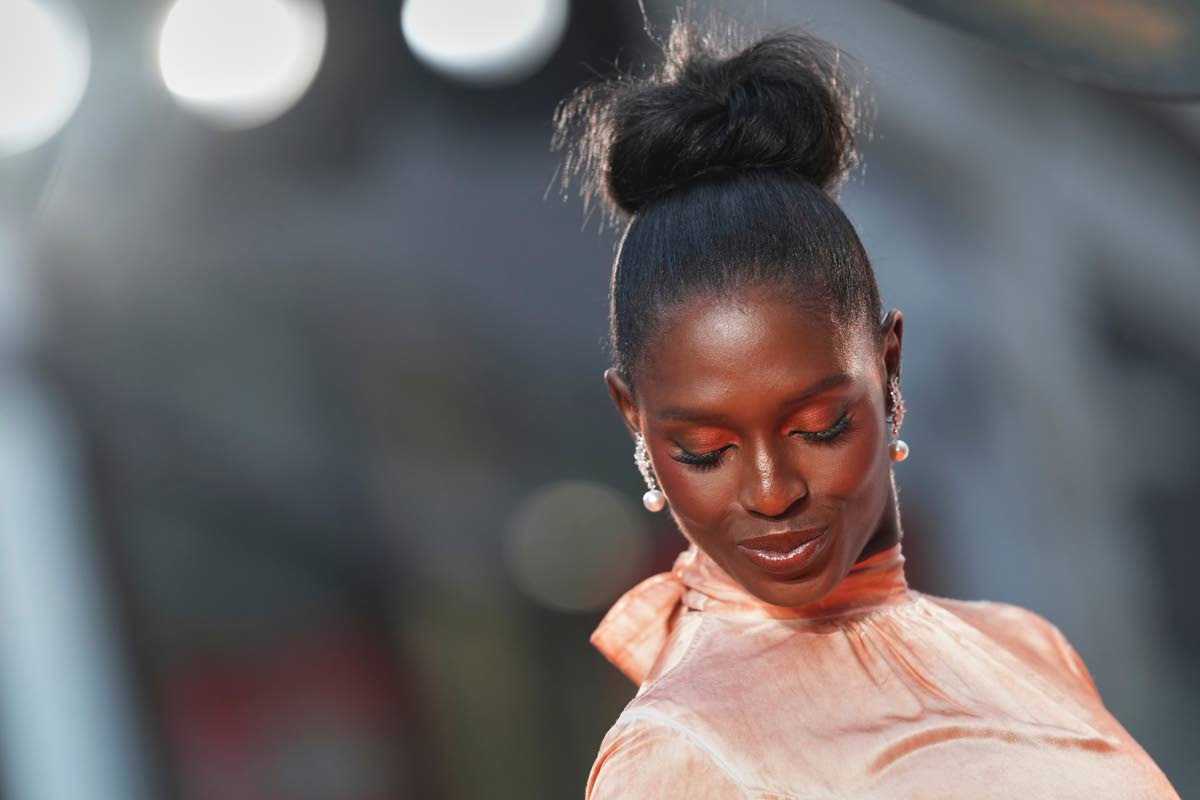 A close-up of Jodie Turner-Smith’s hair and make-up. Her voluminous high top-knot bun was created by Marcia Lee, while Joey Choy created her peach-toned make-up look.