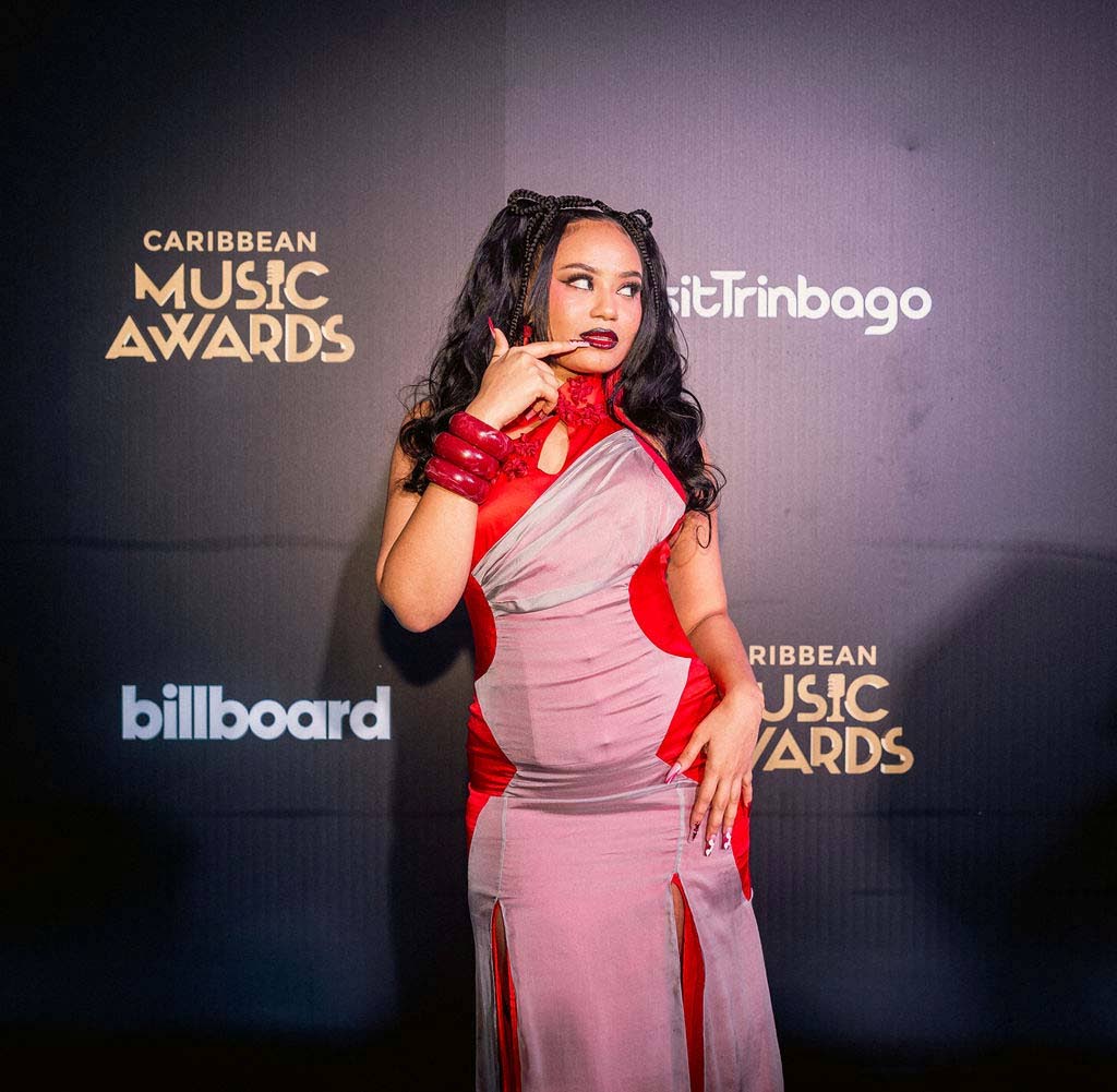 Moliy, winner of Dancehall Collaboration of the Year and Dancehall Song of the Year, makes a statement in a pink and red contrast-trimmed dress by Kim Hui Studio.