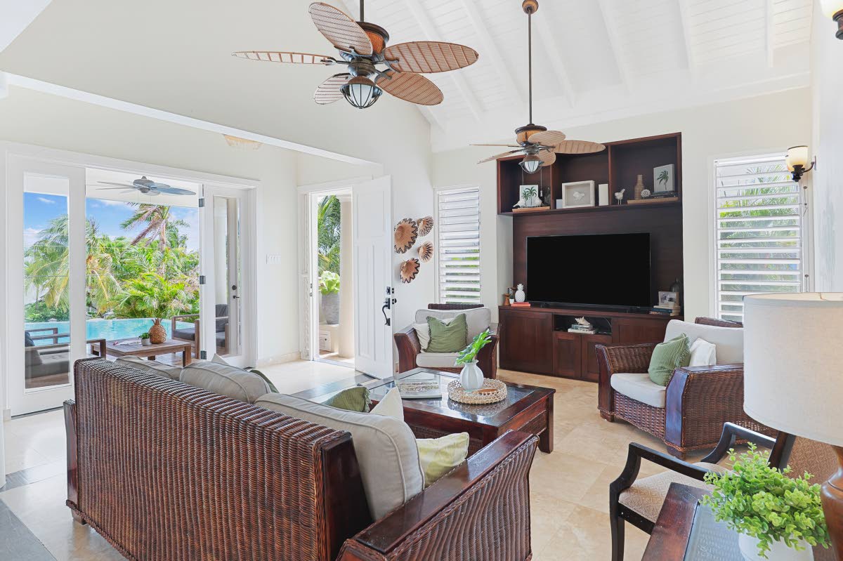 The sea-breeze living room, extending to the porch and pool, is as comfortable as it gets.