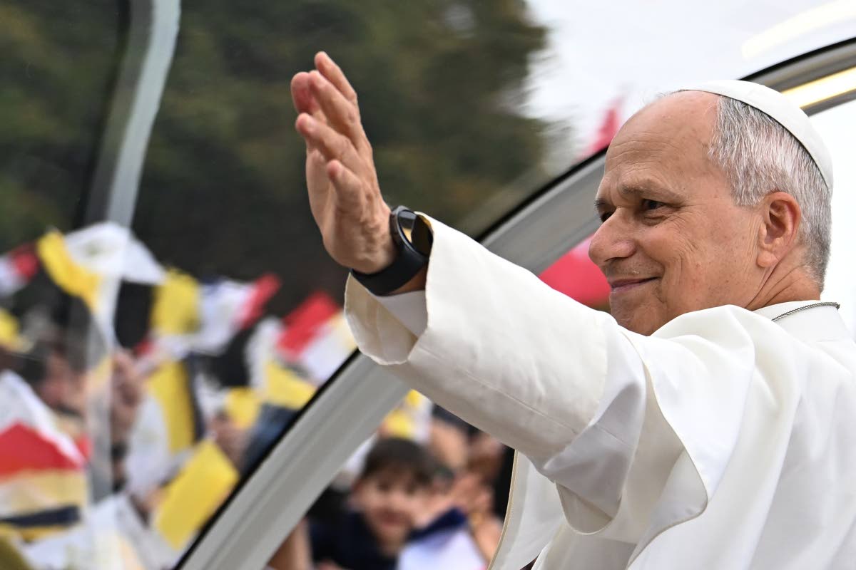 
Pope Leo XIV waves to the crowd on the Champs Elysees avenue before a mass at the Place de la Concorde in Paris on Saturday.