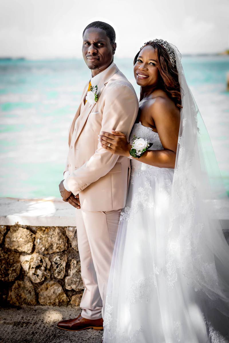 Camille stands proudly behind her husband, Arthur, as they celebrate their new chapter.
