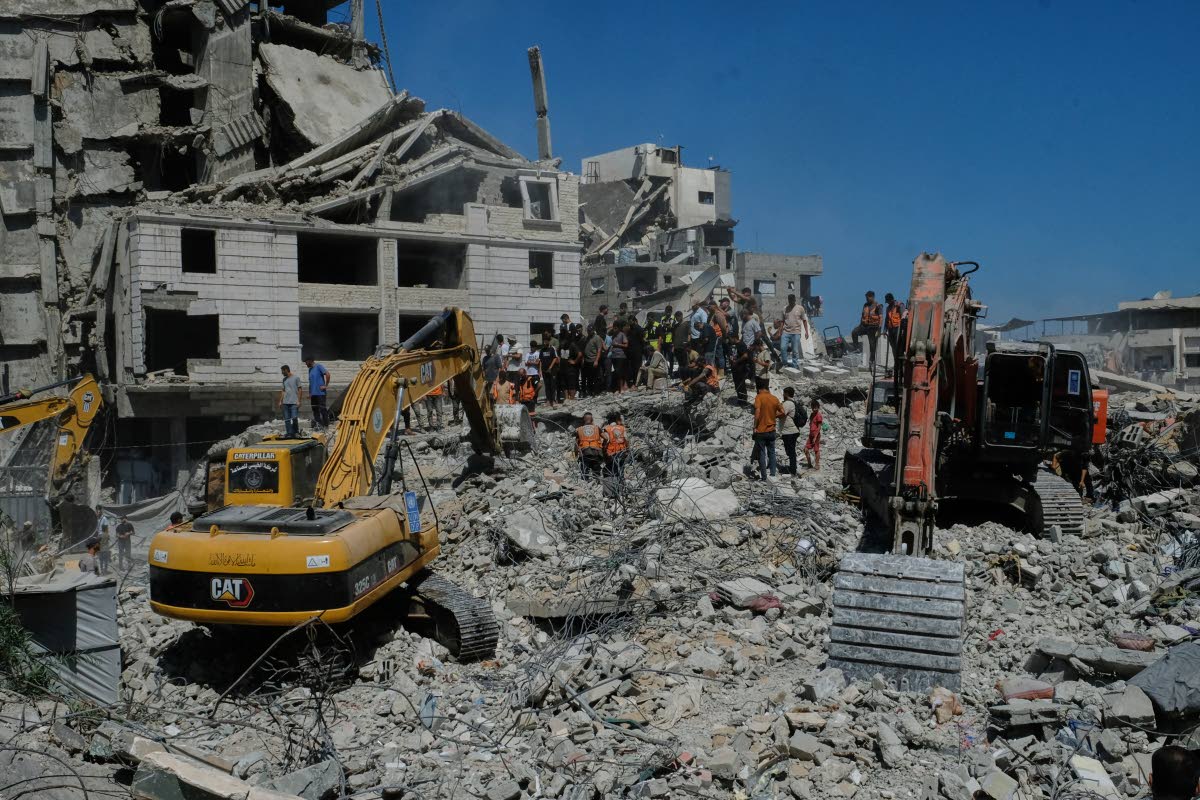 Palestinian civil defence crews search for bodies and survivors in the rubble of a collapsed building that housed displaced Palestinians and was heavily damaged during the Israel-Hamas war, in Gaza City, on Wednesday, September 16, 2026. 