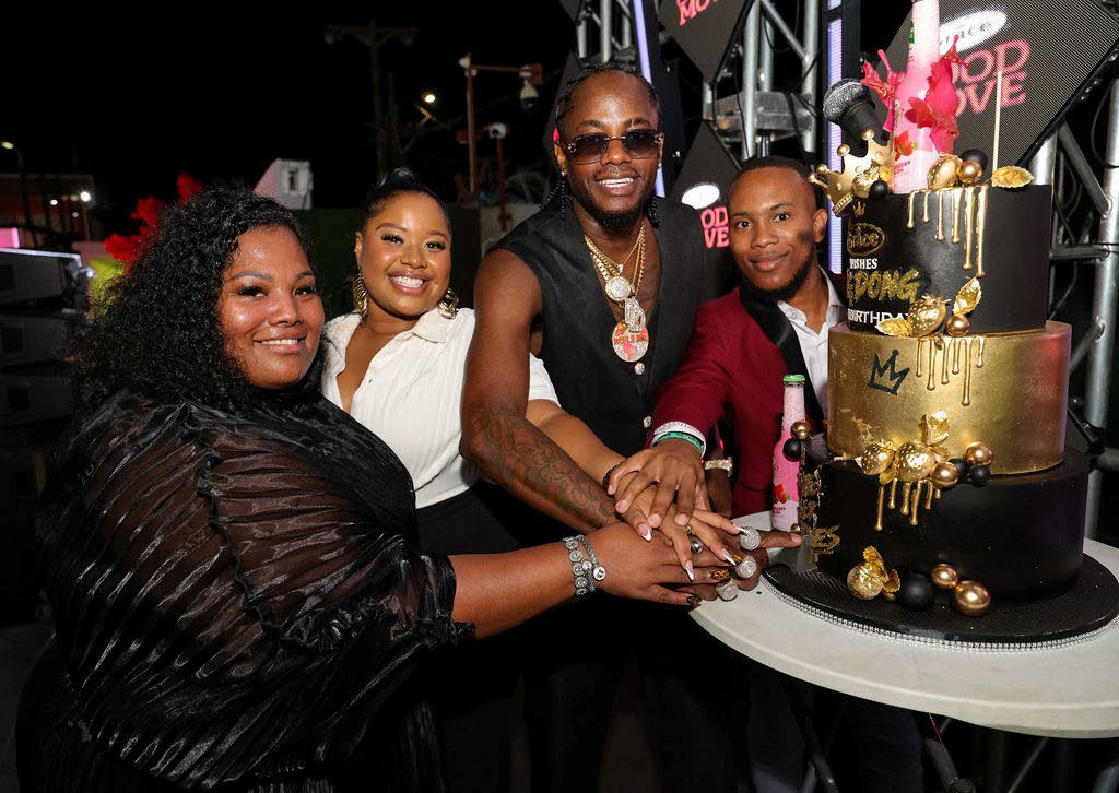 Kemar ‘Ding Dong’ Ottey (second right), Grace Foods global ambassador, cuts his birthday cake alongside Grace Foods representatives (from left) Jhanelle Francis, consumer services manager; Breanna Golding, shopper experience officer; and Kemar Pusey, s