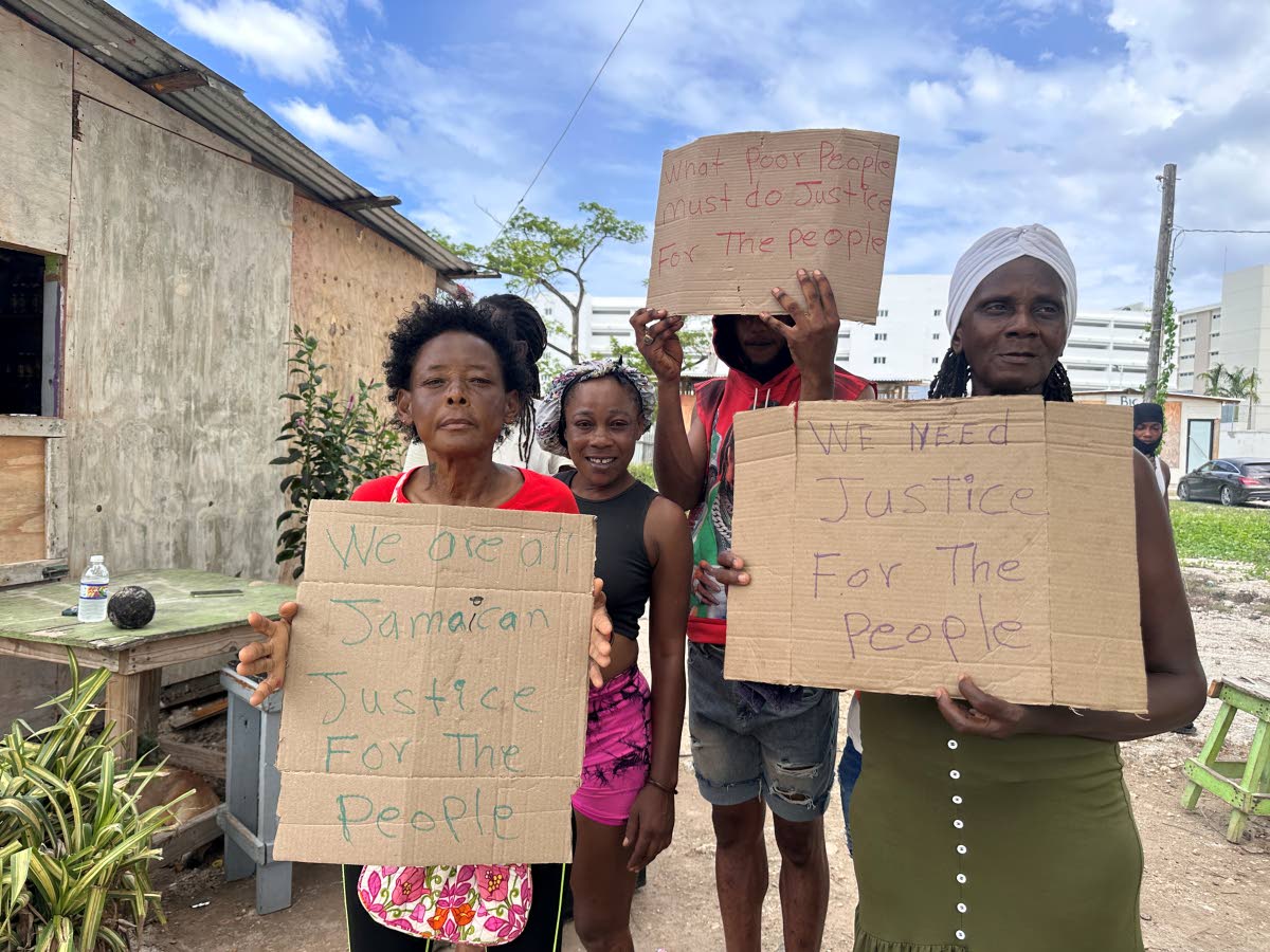 Residents of Coopers Pen, Trelawny stage a protest yesterday in response to a cease-and-desist order demanding that they not build any structures on the controversial property.