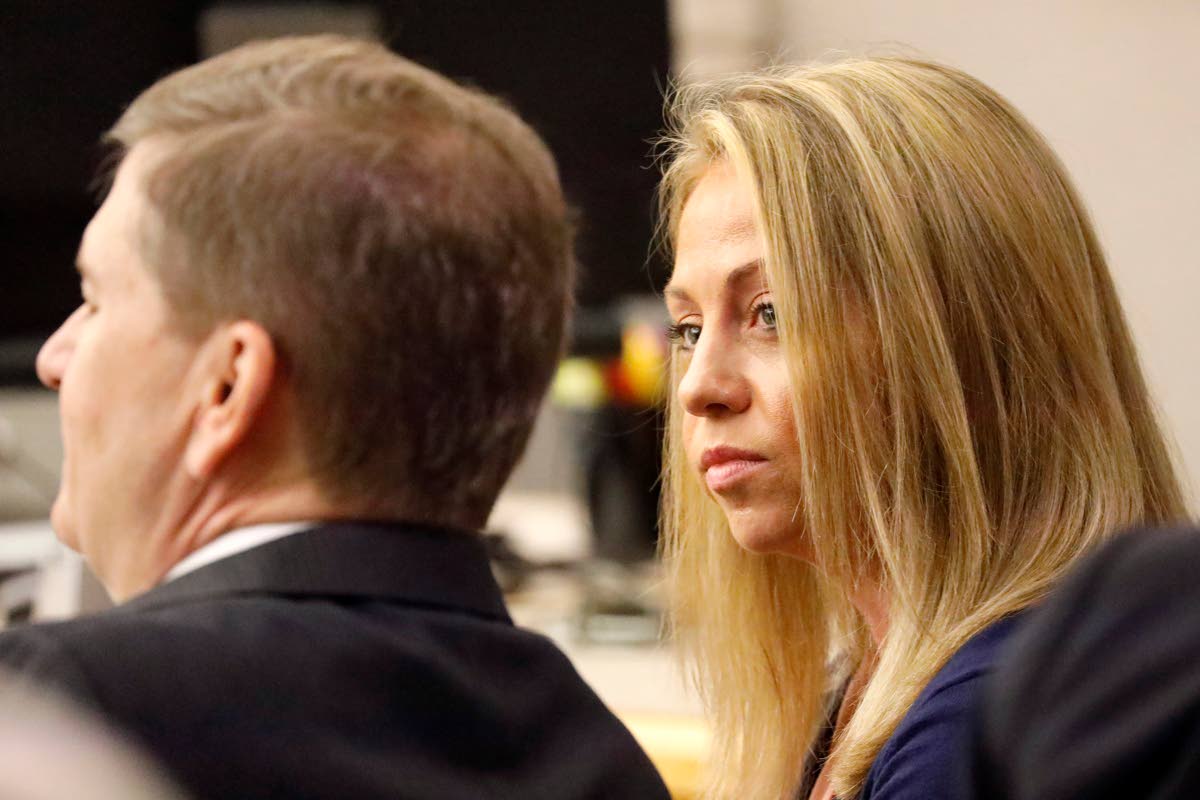 FILE - Fired Dallas police officer Amber Guyger looks toward her attorney before proceedings in her murder trial in Dallas on Sept. 25, 2019. (Tom Fox/The Dallas Morning News via AP, Pool, File)