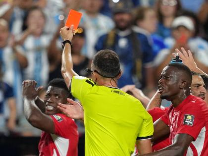 Referee Joao Pinheiro (centre), of Portugal, gives a red card to Switzerland’s Breel Embolo (left) during the World Cup quarterfinal football match against Argentina in Kansas City, Missouri, Saturday, July 11.
