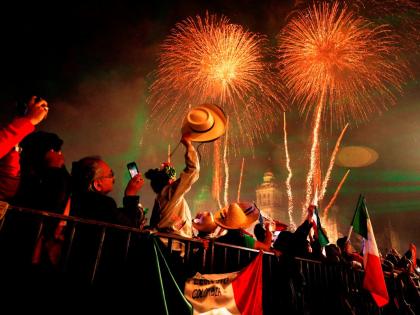 In this 2019 photo, revellers celebrate as fireworks explode over the Metropolitan Cathedral after then president Andrés Manuel López Obrador gave the annual independence shout from the balcony of the National Palace to kick off Independence Day celebrat