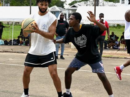 Denver Nuggets’ Jamal Murray (left) and Vauxhall High’s Damarian Taylor at the Jamal Murray Basketball Camp held at Mount Alvernia High last weekend.