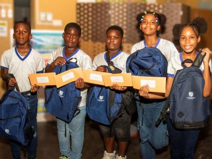 From left: Nathan Williams, Ronaldo O’Connor, Keneik Reid, Najae Biggs and Alana Pottinger from Old Harbour Bay Primary School, show off their backpacks and financial aid vouchers as they were more than 1,000 beneficiaries of Excelerate Energy’s Back-t