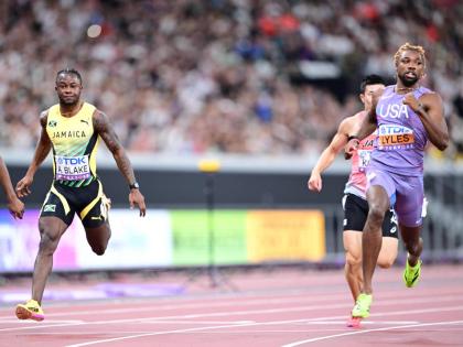 Jamaica’s Ackeem Blake (left) and the United States’ Noah Lyles come through the tape in a 100-metre heat at the World Athletics Championships inside the Japan National Stadium yesterday.