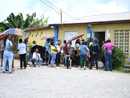 People are seen waiting in Edgewater to cast their votes.