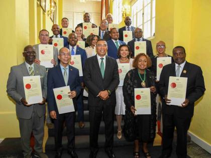 The prime minister and members of his cabinet pose for a photo: In front row (from left) are: Desmond McKenzie; Dr. Horace Chang; Prime Minister Dr Andrew Holness; Olivia Grange; Robert Montague. Second row: Daryl Vaz; Pearnel Charles Jr; Audrey Marks; Dan