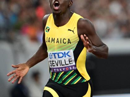 Jamaica’s Oblique Seville celebrates after crossing the finish line in first place, mining gold and claiming the World Champion title in the men’s 100m on Sunday.