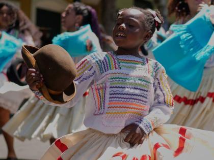 A young member of the Afro-Bolivian community dances the ‘saya’, a traditional dance performed with drums and chants, as part of the celebrations to mark the National Day of Afro-Bolivian people, in La Paz.