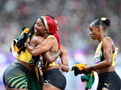 Jamaica’s Jonielle Smith (left) hugs Shelly-Ann Fraser-Pryce while Tina Clayton looks on after the three, along with Tia Clayton, mined silver in the women’s 4x100-metre relay on Sunday’s final day of the World Athletics Championships in Tokyo, Japan