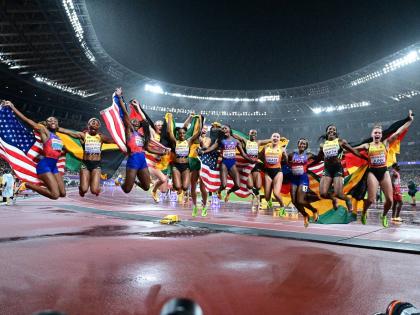 Members of the Jamaica, United States and Germany teams celebrate after winning the medals in the women’s 4x100m final. The US took gold ahead of Jamaica, followed by Germany.