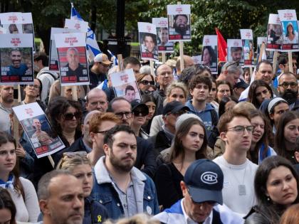 People hold pictures of hostages as they attend a pro-Israel vigil on the anniversary of a Hamas attack on Israel that triggered the ongoing war in Gaza in front of McGill University in Montreal, Canada on October 7, 2024.