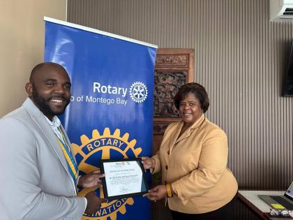 From left: Lemar James, president of the Rotary Club of Montego Bay, presents a certificate of appreciation to Dr Michelle Walden-Pinnock, regional director, Region Four of the Ministry of Education, Skills, Youth and Information, during the club’s weekl