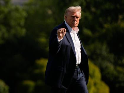 President Donald Trump gestures as he arrives at the White House, Friday, September 26, 2025, in Washington. (AP Photo/Julia Demaree Nikhinson)