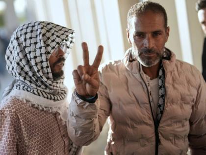 Activists from the Global Sumud Flotilla give the peace sign after arriving at Istanbul Airport in Istanbul, Turkey.