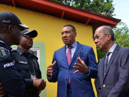 Prime Minister Dr Andrew Holness (second right) in dialogue with Deputy Prime Minister and  Minister of National Security, Dr Horace Chang (right), Police Commissioner, Dr Kevin Blake (left) and Assistant Commissioner of Police for Area 5,  Christopher Phi