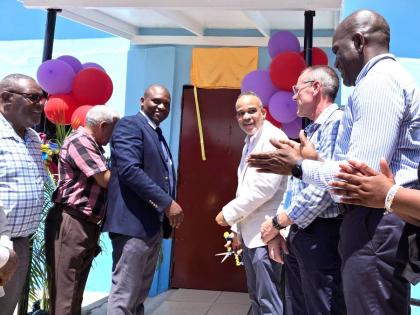 Jamalco has partnered with Bustamante High School to transform two classrooms into state-of-the-art literacy and numeracy laboratories at a cost of $2 million. In the photo, Jamalco’s Managing Director, Marvin Jackson, cuts the ribbon with Bustamante Hig