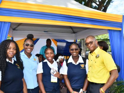 Data Protection Officer Desmond Pringle (right) shares in a quick picture with students from Moneague College at the Court Administration Division’s Public Education Day Symposium.
