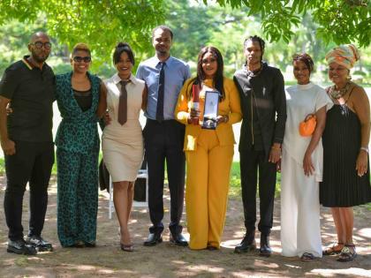 Family and friends of the late Garnett Silk celebrate his posthumous OD. From left: Delroy Collins; Kemilee McLymont; Arrayma Smith (daughter); Fabian Smith (son); Novlyn Banton (spouse); Garnet Smith (son); Wayzero Smith (daughter) and former manager Brid