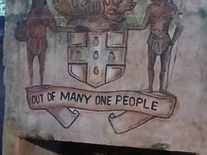 The Jamaica coat of arms is painted on one of the structures at Great Huts Eco Resort in Boston, Portland.