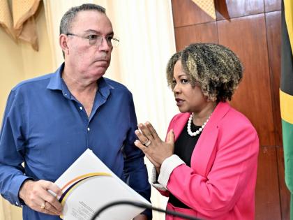 Information Minister Dr Dana Morris Dixon chats with Daryl Vaz, minister of energy and transport, at a special press briefing on Tropical Storm Melissa at Jamaica House in St Andrew on Thursday.