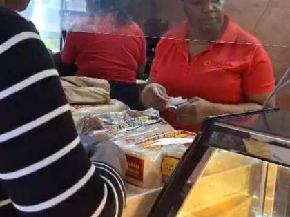 A customer buying baked goods at Top Loaf Bake Shops in Mandeville, Manchester on October 27, 2025, as Hurricane Melissa nears.