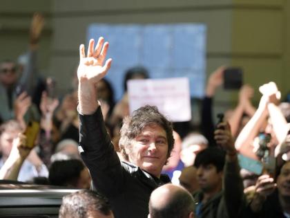 Argentina’s President Javier Milei waves to supporters after voting during legislative midterm elections in Buenos Aires, Argentina, Sunday, October 26, 2025.