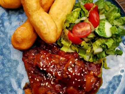 This sweet and sour mackerel, topped with sesame seeds, was paired with fried festival and a side of garden vegetables.