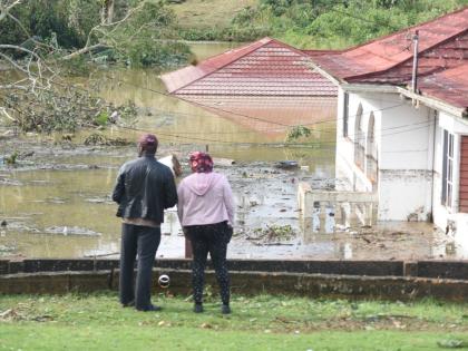 Houses and vehicles are seen submerged at Gibson Close, off Ward Avenue in Mandeville, following Hurricane Melissa.