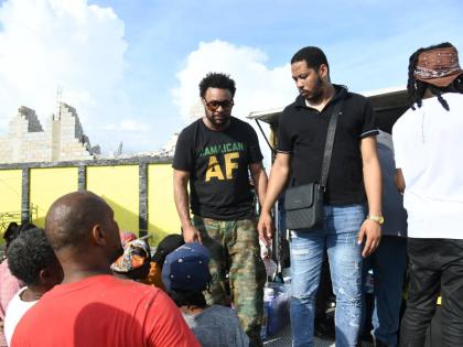 Shaggy (left) provides care packages to residents of St Elizabeth on Crane Road in the parish on Friday, October 31.