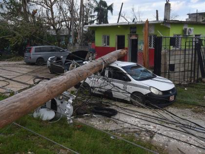 A utility pole which broke during the passage of Hurricane Melissa fell on a parked car in Salt Marsh, Trelawny.