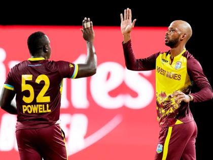 
West Indies’ Roston Chase (right) celebrating with Rovman Powell.