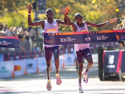 Benson Kipruto (left) and Alexander Mutiso cross the finish line to win first and second place, respectively, in the men’s elite division of the New York City Marathon yesterday in New York. 