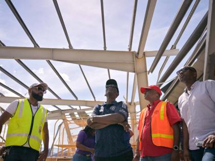 Minister of Local Government and Community Development,  Desmond McKenzie (second left), with Mayor of Black River Richard Solomon (left), along with other key stakeholders. survey the extensive damage to the Black River Market in St.Elizabeth, following t