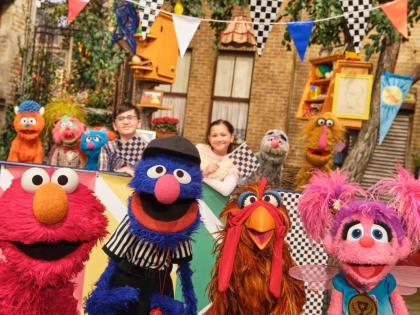 This image released by Sesame Workshop shows muppet characters Elmo (left), Grover (second left), and Abby (right), from the ‘Sesame Street’ episode ‘Elmo Runs the Race’.
