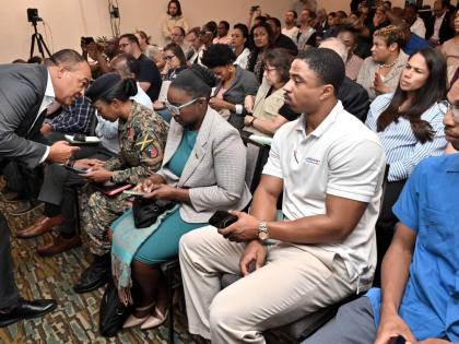Dr Christopher Tufton (left), minister of health and wellness; with Lieutenant Colonel Gail Ranglin Edwards (second left), director of the Health Services Corps of the Jamaica Defence Force, at the Ministry of Health and Wellness PAHO/WHO Health Cluster Hu