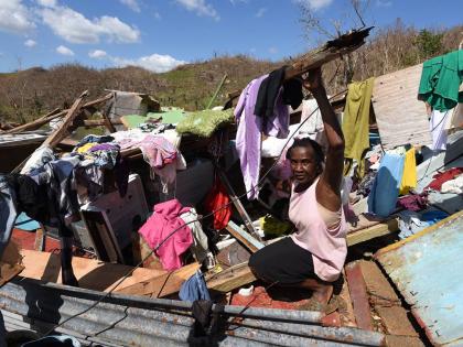 Sixty year old Juliet Clarke of Ipswich, St. Elizabeth, sits atop the rubble of her three bedrood board house after it collapsed during the passage of Hurricane Melissa.
